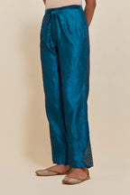 Teal Silk pants with hand embroidered leaf motifs with delicate sequins work at hem.