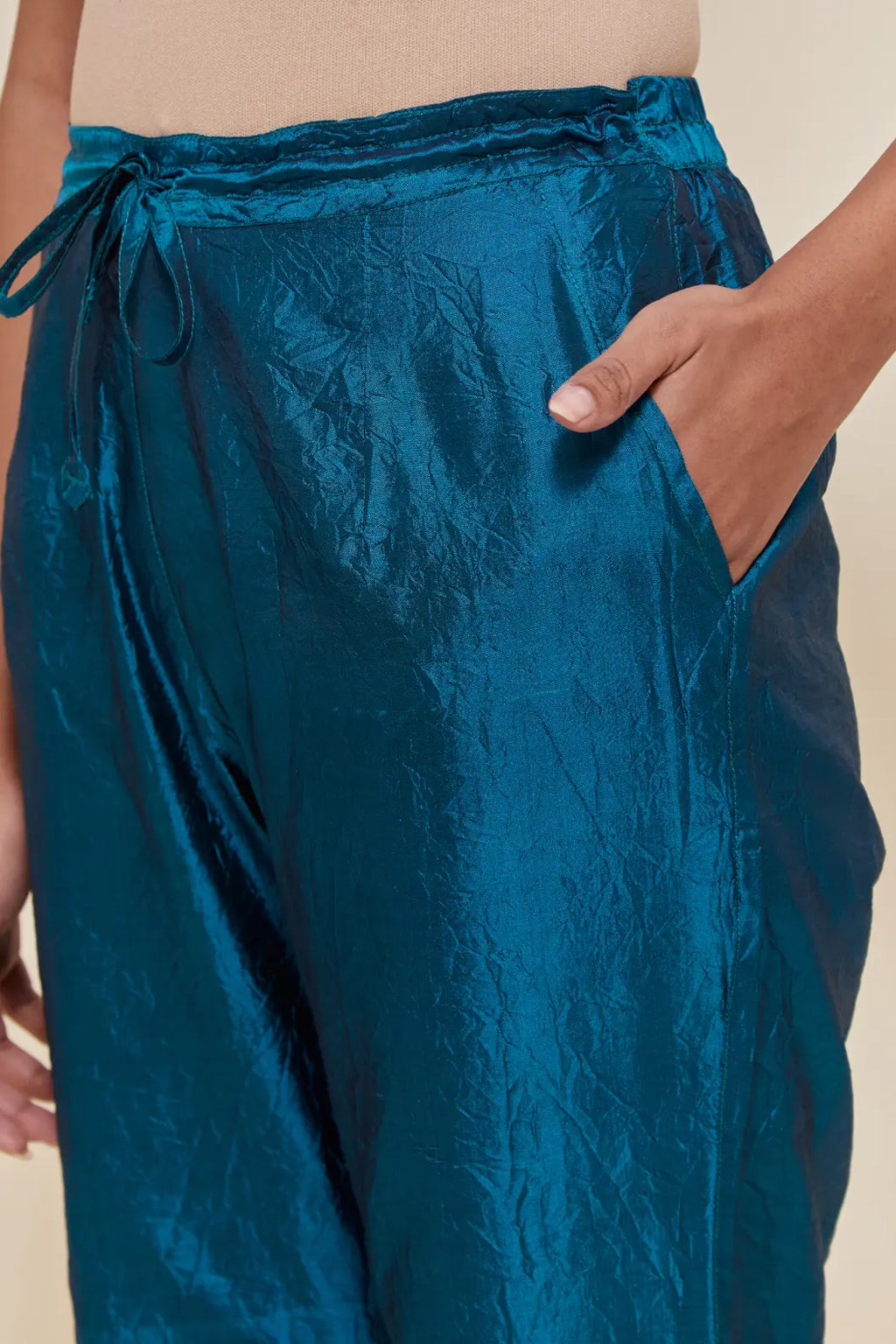 Teal Silk pants with hand embroidered leaf motifs with delicate sequins work at hem.
