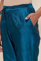 Teal Silk pants with hand embroidered leaf motifs with delicate sequins work at hem.
