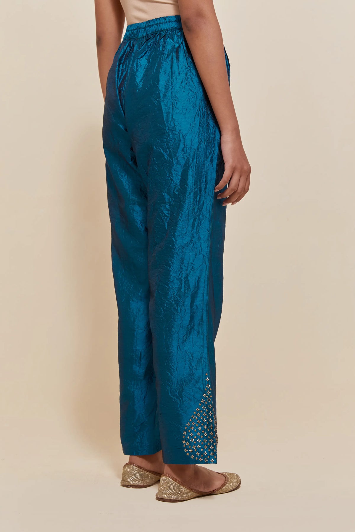 Teal Silk pants with hand embroidered leaf motifs with delicate sequins work at hem.