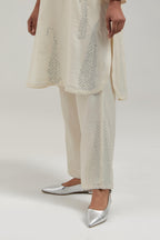 Off white Silk Chanderi short kurta set with hand-embroidered paisley motifs with delicate mirror and sequins work all-over the kurta.