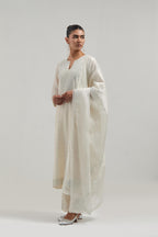 Off white silk Chanderi dupatta with silk organza at the sides, finished with delicate scalloped edges, highlighted by hand-embroidered mirror & sequins work.