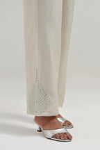 Off white Silk Chanderi pants with hand embroidered leaf motifs with delicate mirror & sequins work at hem.