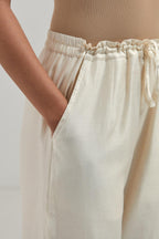 Off white Silk Chanderi pants with hand embroidered leaf motifs with delicate mirror & sequins work at hem.