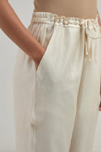 Off white silk Chanderi straight pants with narrow organza scalloped hem and hand-embroidered diamond motifs with delicate mirror & sequins work at the sides.