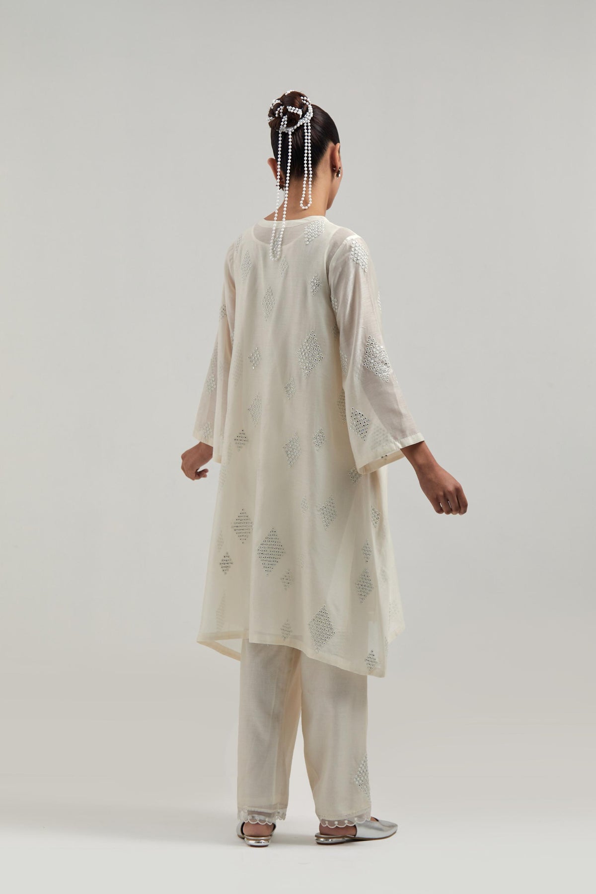 Off white Silk Chanderi A-line short kurta set with hand embroidered diamond motifs with delicate mirror and sequins work all-over the kurta.