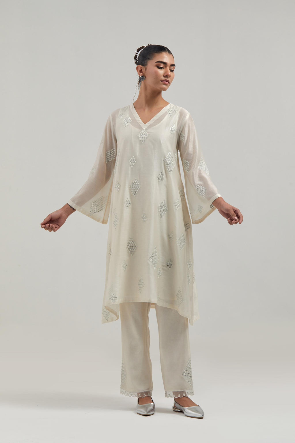 Off white Silk Chanderi A-line short kurta set with hand embroidered diamond motifs with delicate mirror and sequins work all-over the kurta.