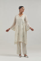 Off white Silk Chanderi A-line short kurta set with hand embroidered diamond motifs with delicate mirror and sequins work all-over the kurta.