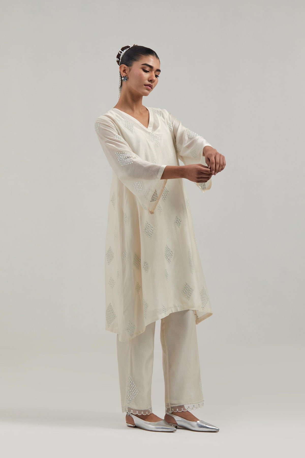Off white Silk Chanderi A-line short kurta set with hand embroidered diamond motifs with delicate mirror and sequins work all-over the kurta.