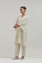 Off white Silk Chanderi A-line short kurta set with hand embroidered diamond motifs with delicate mirror and sequins work all-over the kurta.