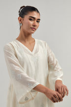 Off white Silk Chanderi A-line short kurta set with hand embroidered diamond motifs with delicate mirror and sequins work all-over the kurta.
