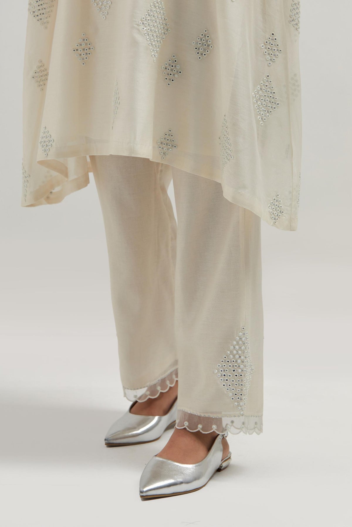 Off white Silk Chanderi A-line short kurta set with hand embroidered diamond motifs with delicate mirror and sequins work all-over the kurta.