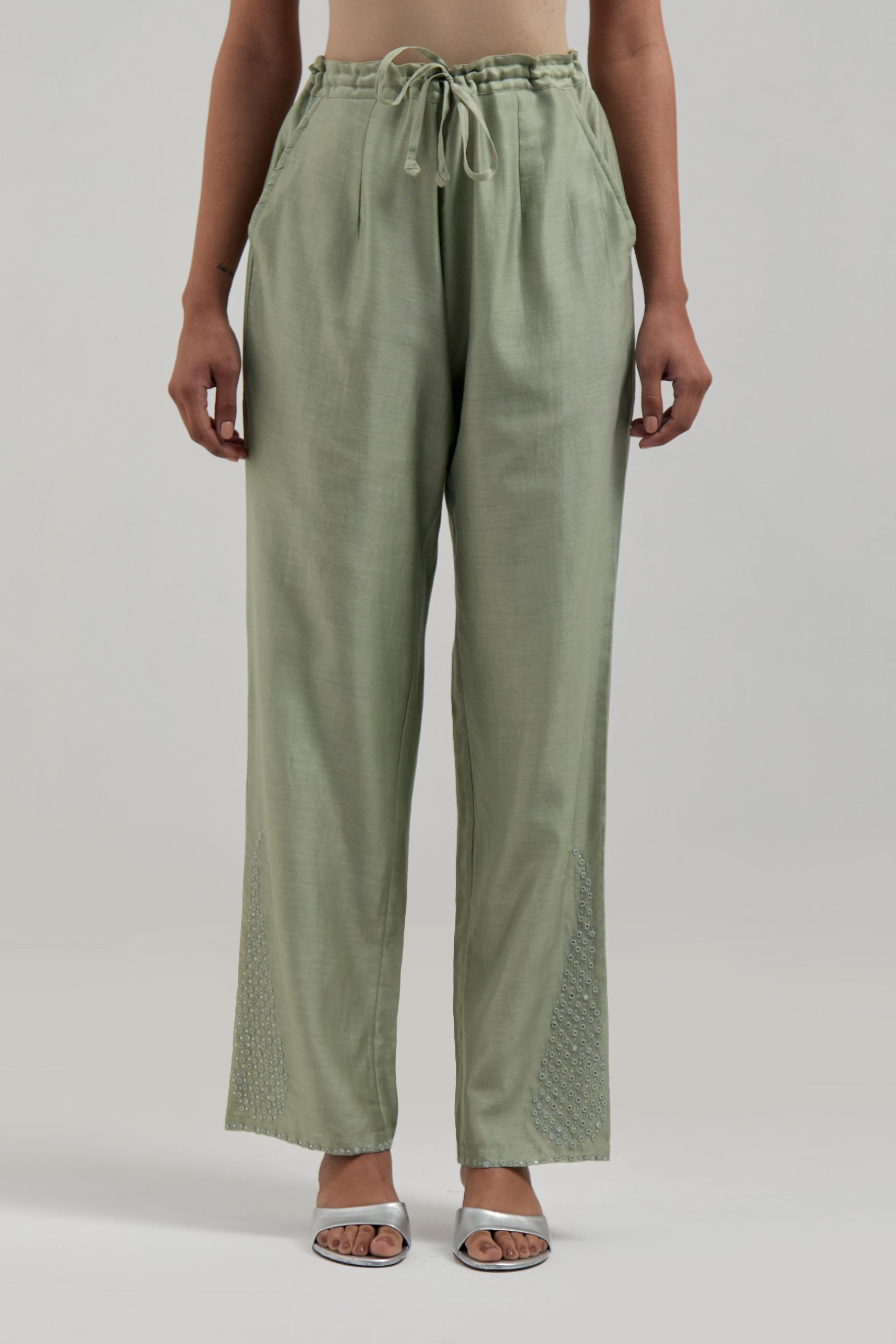 Green silk Chanderi pants with hand-embroidered paisley motifs with delicate mirror and sequins work at the hem.