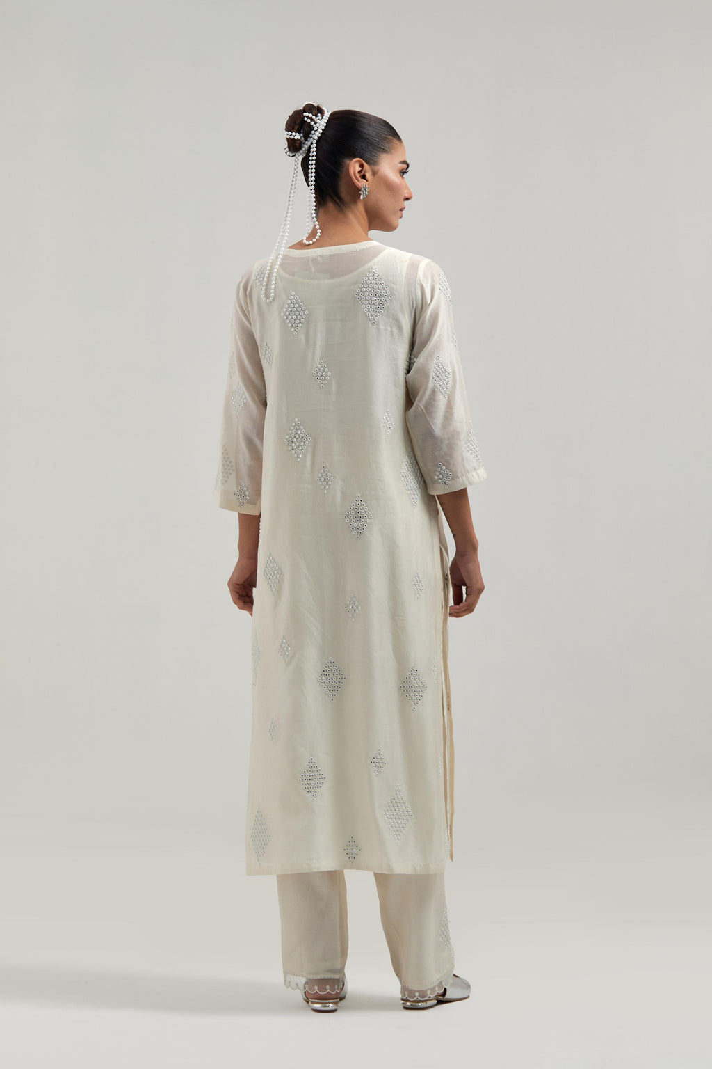 Off white Silk Chanderi straight kurta set with hand embroidered diamond motifs with delicate mirror and sequins work all-over the kurta.