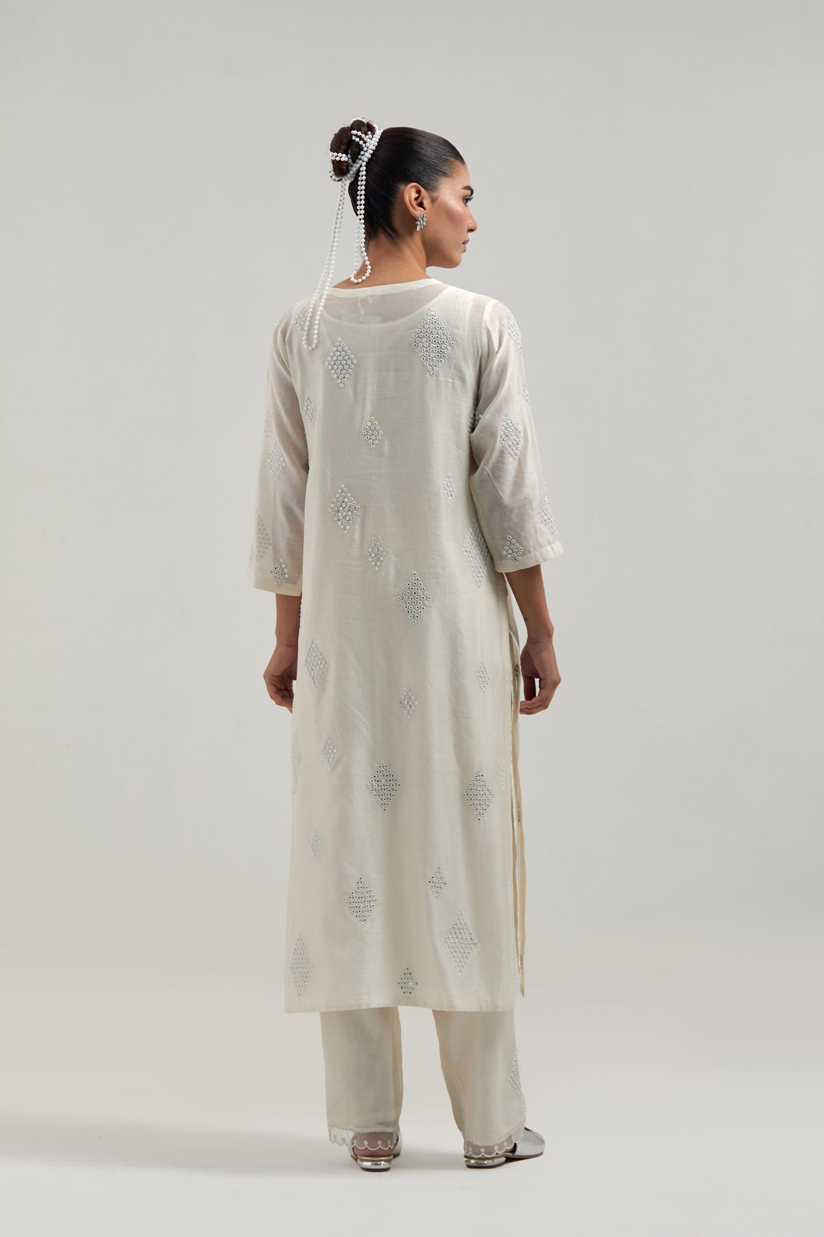 Off white Silk Chanderi straight kurta set with hand embroidered diamond motifs with delicate mirror and sequins work all-over the kurta.