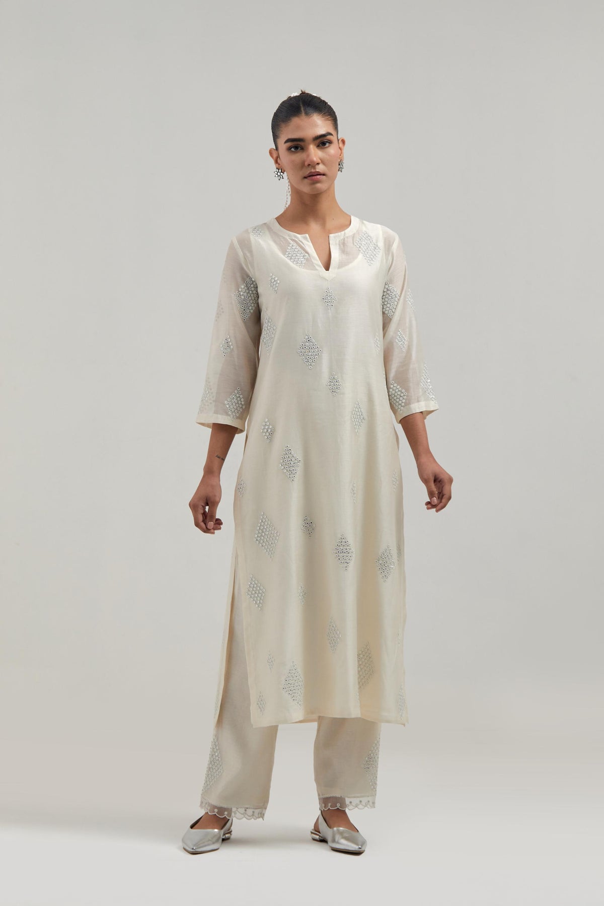 Off white Silk Chanderi straight kurta set with hand embroidered diamond motifs with delicate mirror and sequins work all-over the kurta.