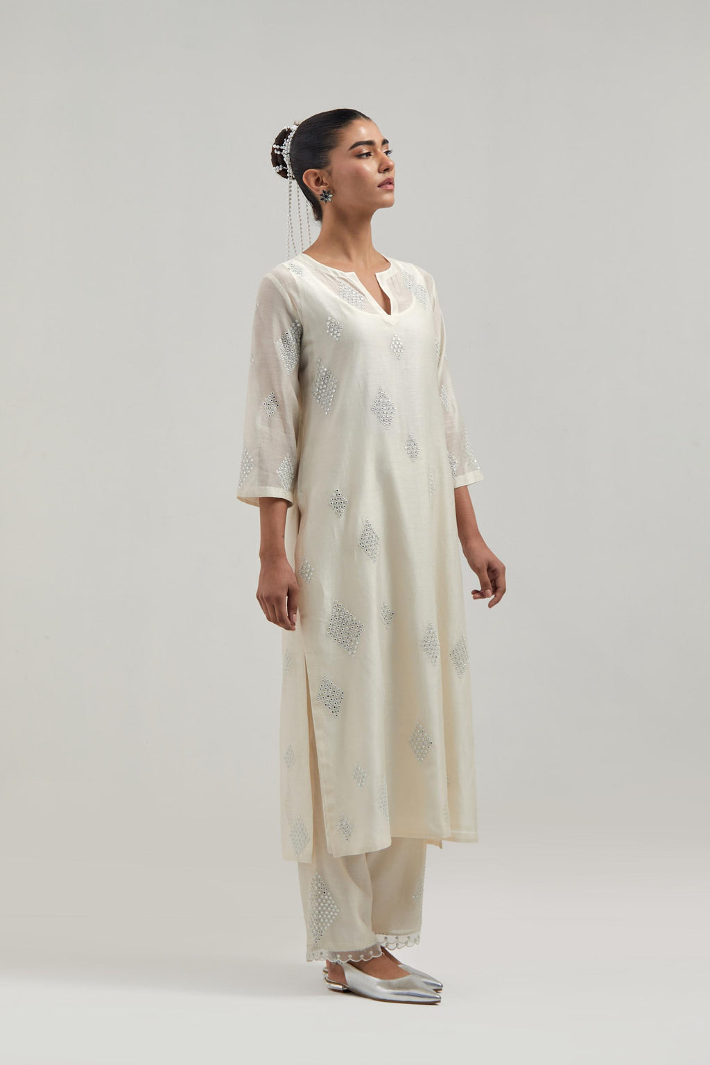 Off white Silk Chanderi straight kurta set with hand embroidered diamond motifs with delicate mirror and sequins work all-over the kurta.