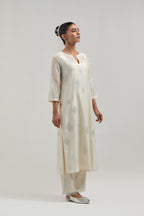 Off white Silk Chanderi straight kurta set with hand embroidered diamond motifs with delicate mirror and sequins work all-over the kurta.