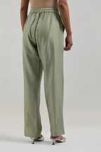 Green silk Chanderi pants with hand-embroidered paisley motifs with delicate mirror and sequins work at the hem.
