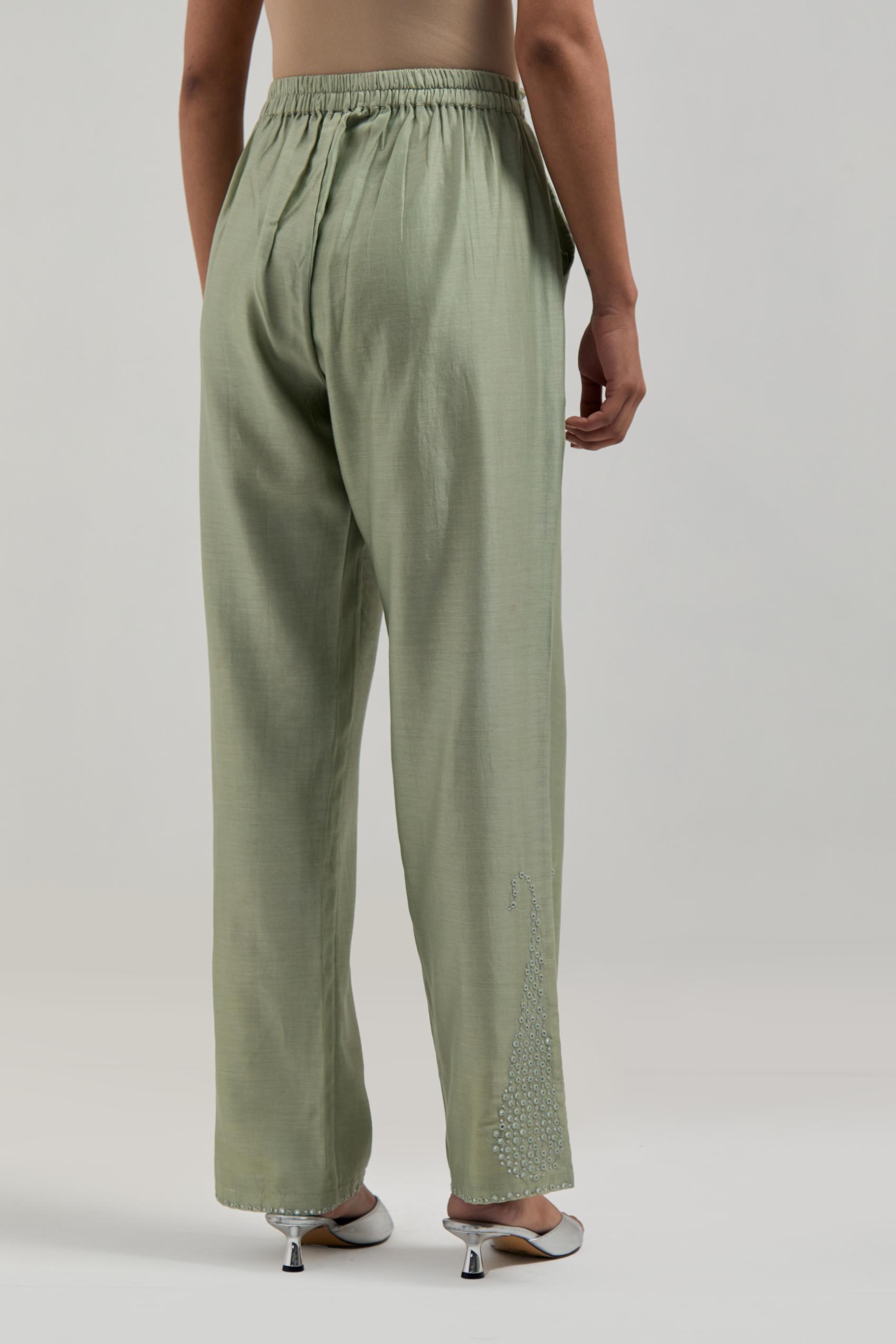 Green silk Chanderi pants with hand-embroidered paisley motifs with delicate mirror and sequins work at the hem.