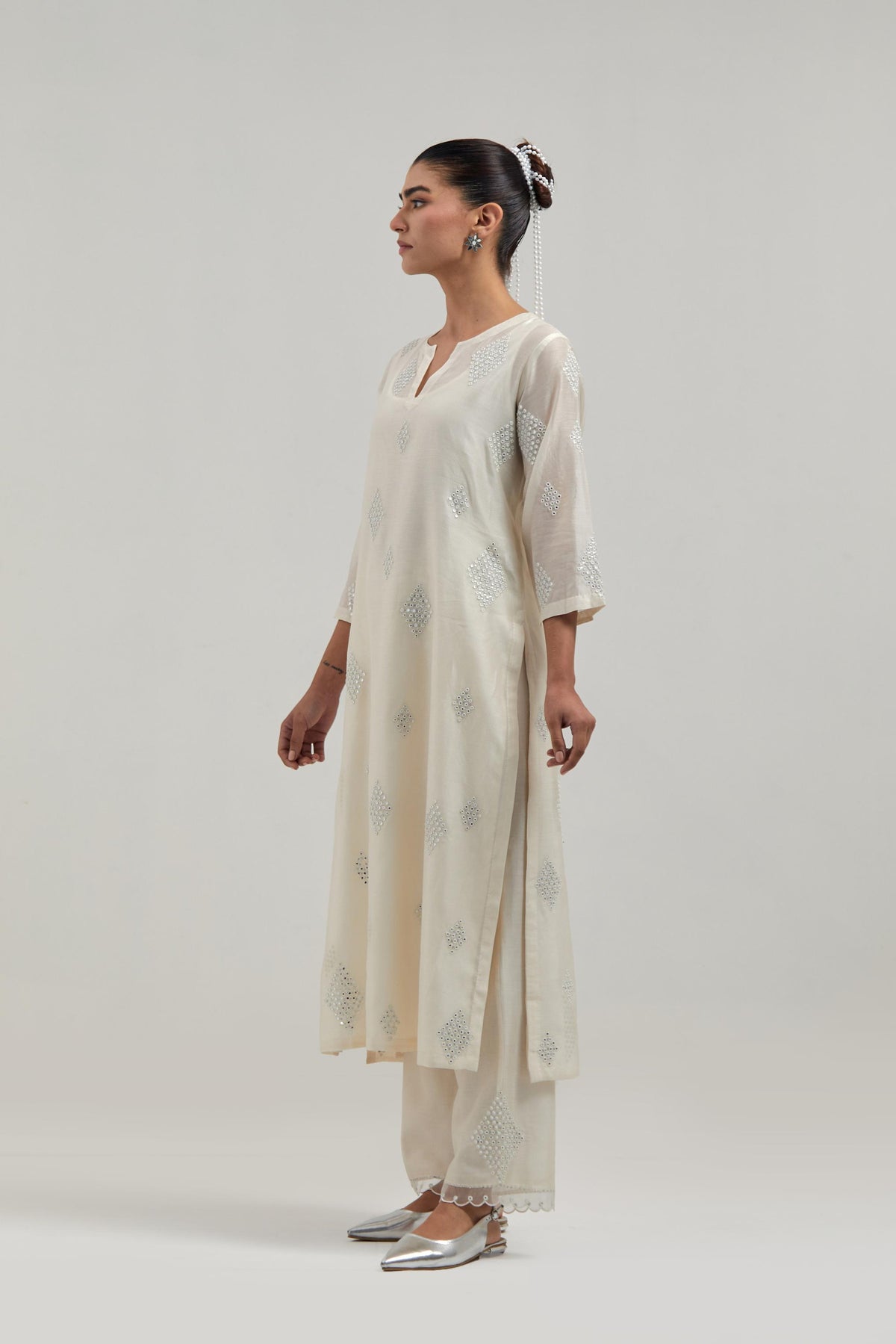 Off white Silk Chanderi straight kurta set with hand embroidered diamond motifs with delicate mirror and sequins work all-over the kurta.