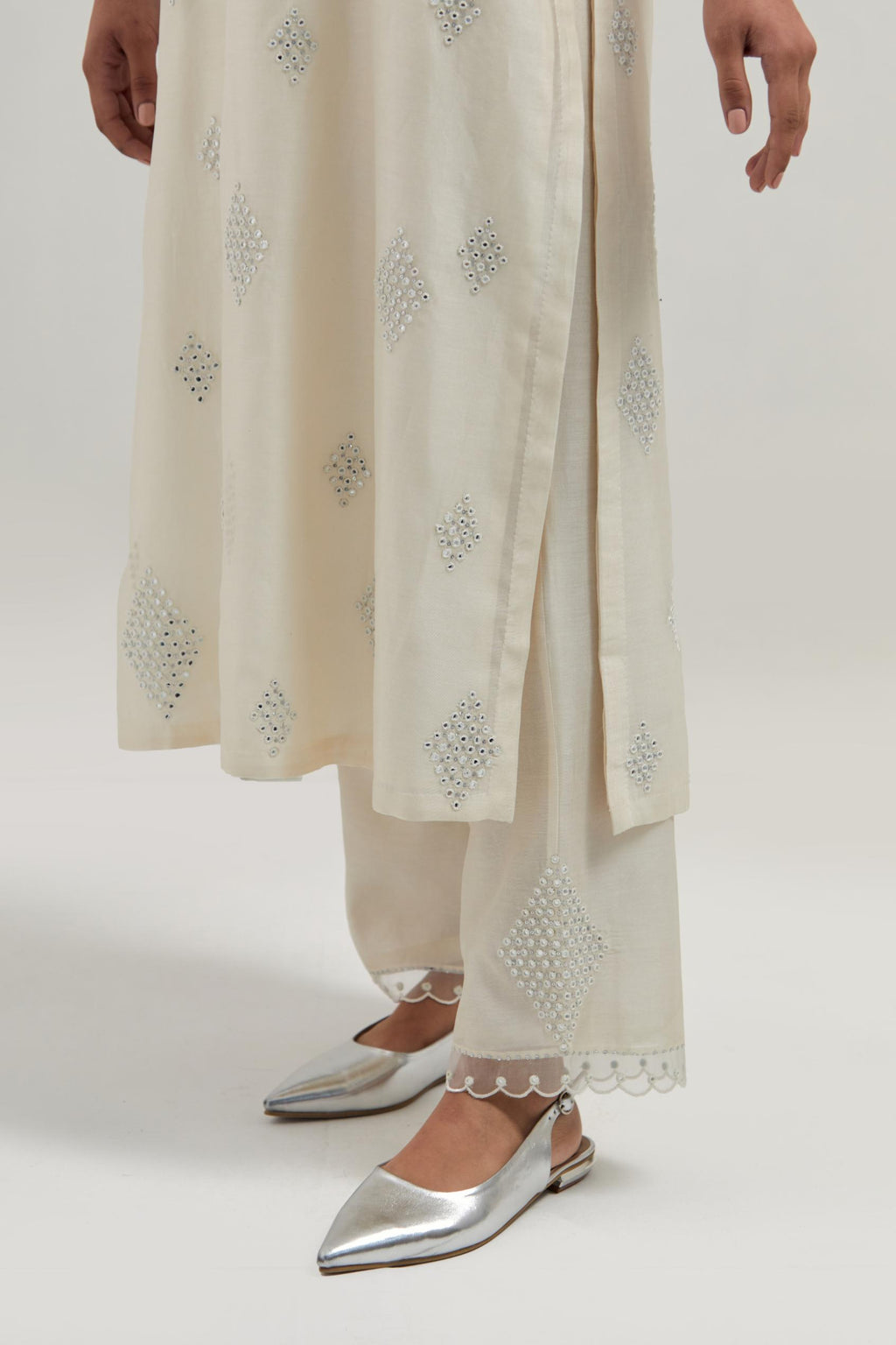 Off white Silk Chanderi straight kurta set with hand embroidered diamond motifs with delicate mirror and sequins work all-over the kurta.