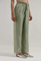 Green silk Chanderi straight pants with narrow organza scalloped hem and hand-embroidered diamond motifs with delicate mirror & sequins work at the sides.