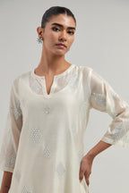 Off white Silk Chanderi straight kurta set with hand embroidered diamond motifs with delicate mirror and sequins work all-over the kurta.