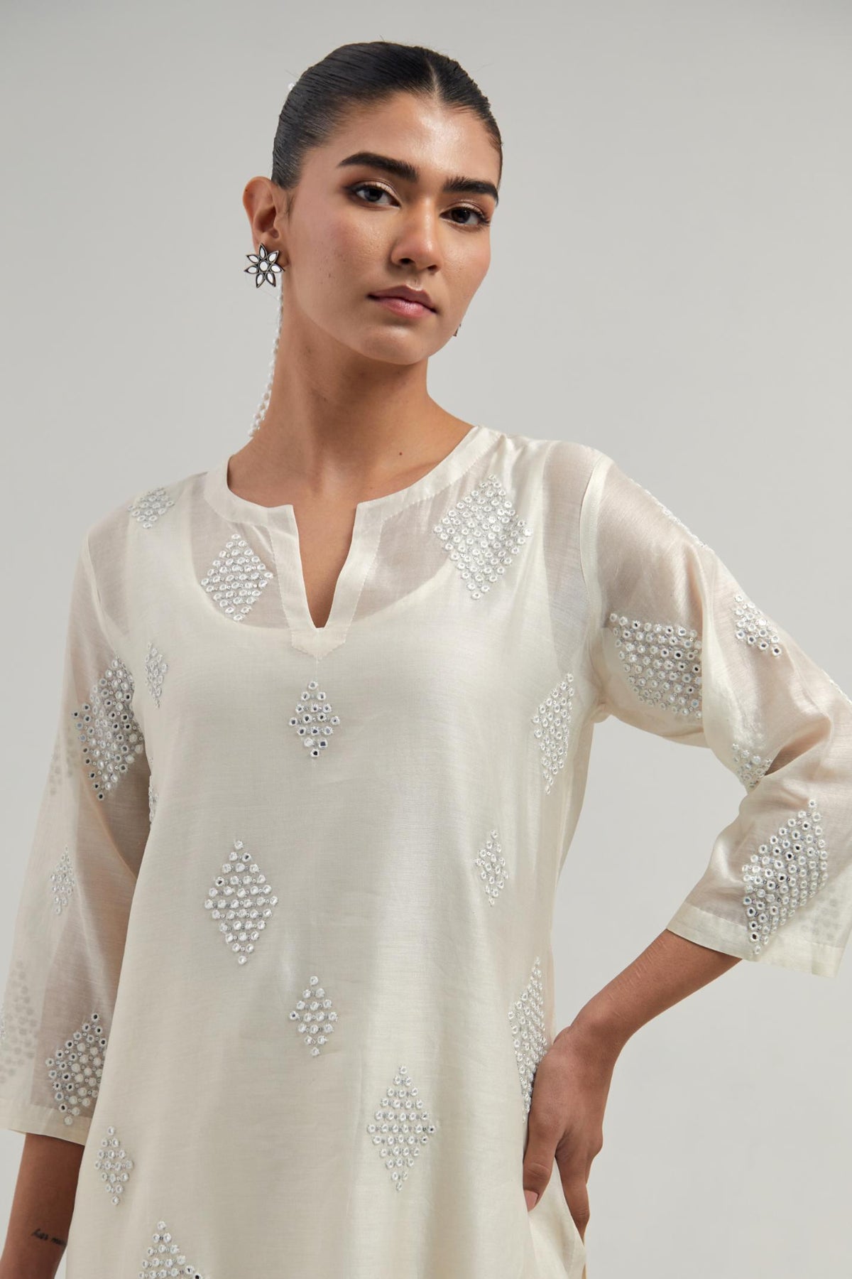 Off white Silk Chanderi straight kurta set with hand embroidered diamond motifs with delicate mirror and sequins work all-over the kurta.
