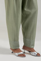 Green silk Chanderi salwar with hand-embroidered mirror & sequins work in a broad border at the hem.