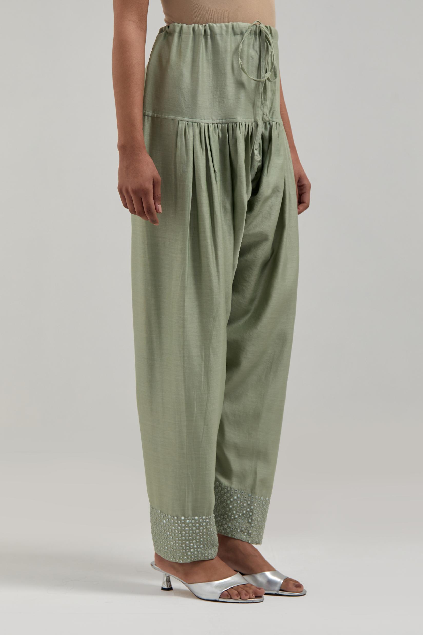 Green silk Chanderi salwar with hand-embroidered mirror & sequins work in a broad border at the hem.