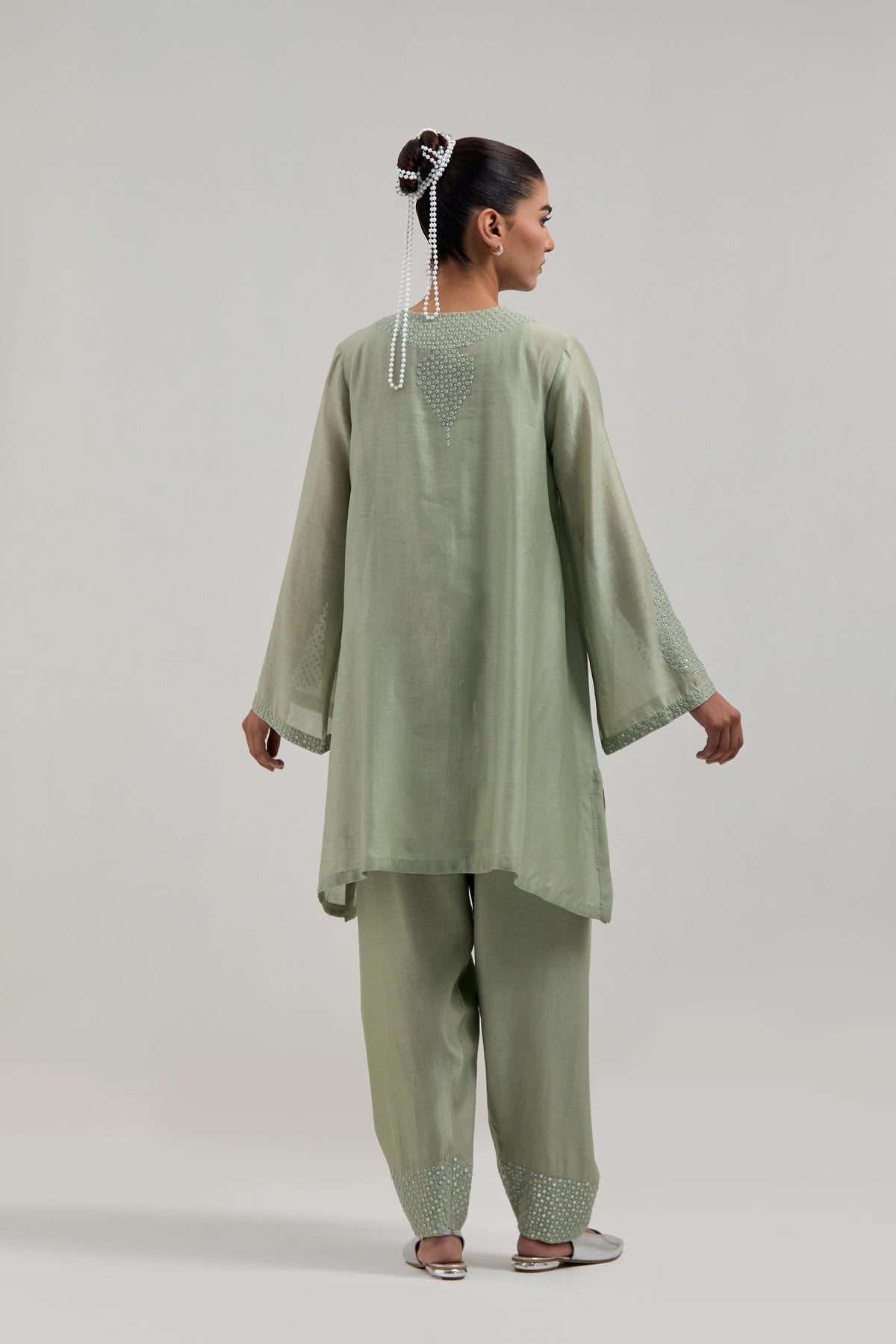 Green silk Chanderi short A-line kurta set with hand-embroidered mirror work at the neck and bell sleeves.