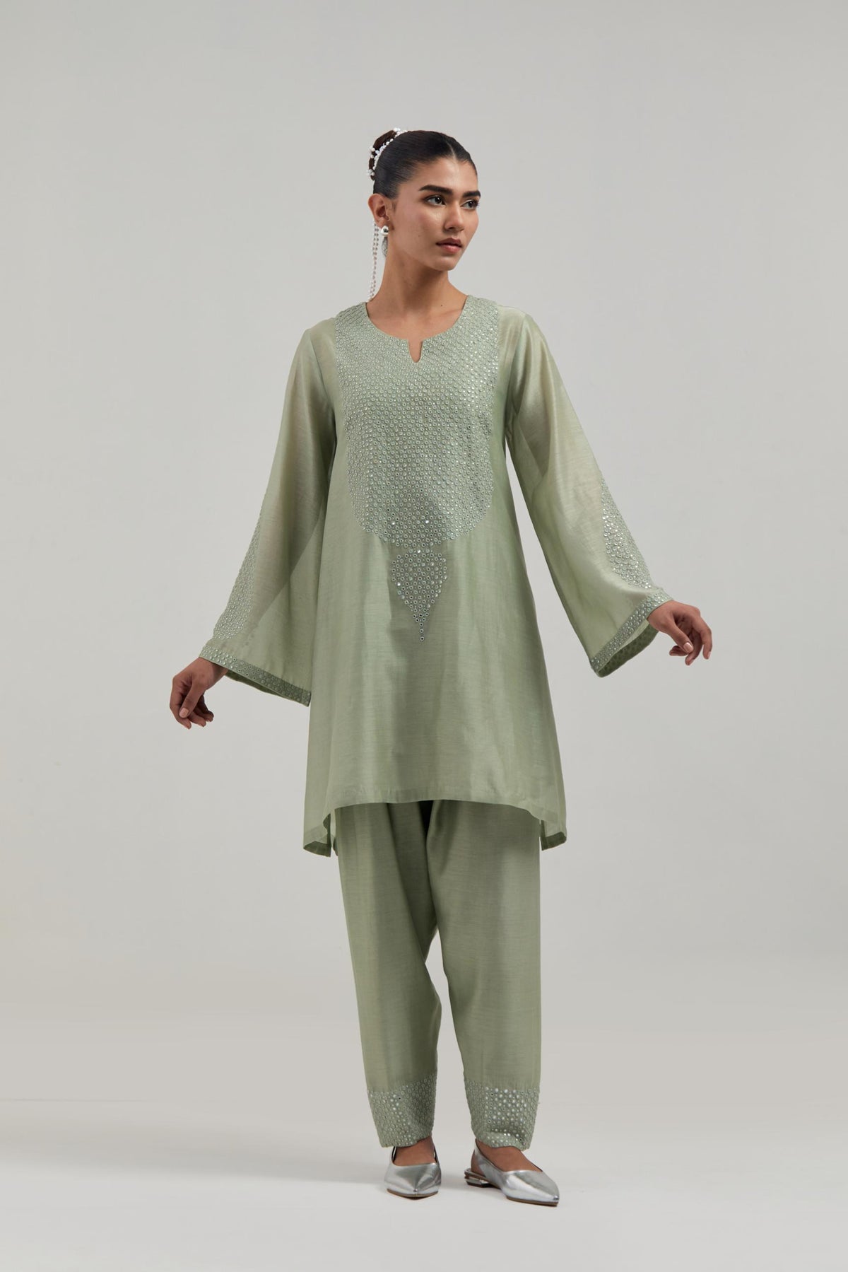 Green silk Chanderi short A-line kurta set with hand-embroidered mirror work at the neck and bell sleeves.