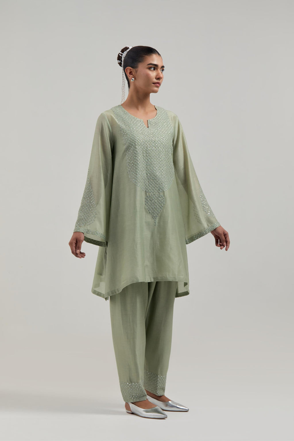 Green silk Chanderi short A-line kurta set with hand-embroidered mirror work at the neck and bell sleeves.