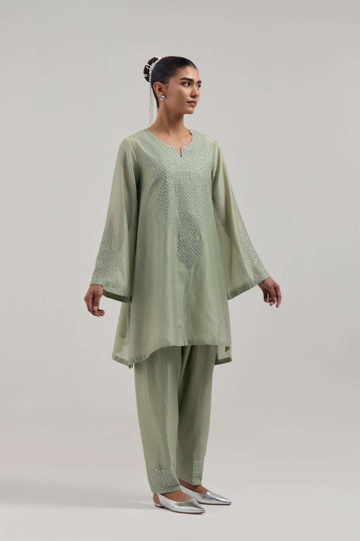Green silk Chanderi short A-line kurta set with hand-embroidered mirror work at the neck and bell sleeves.