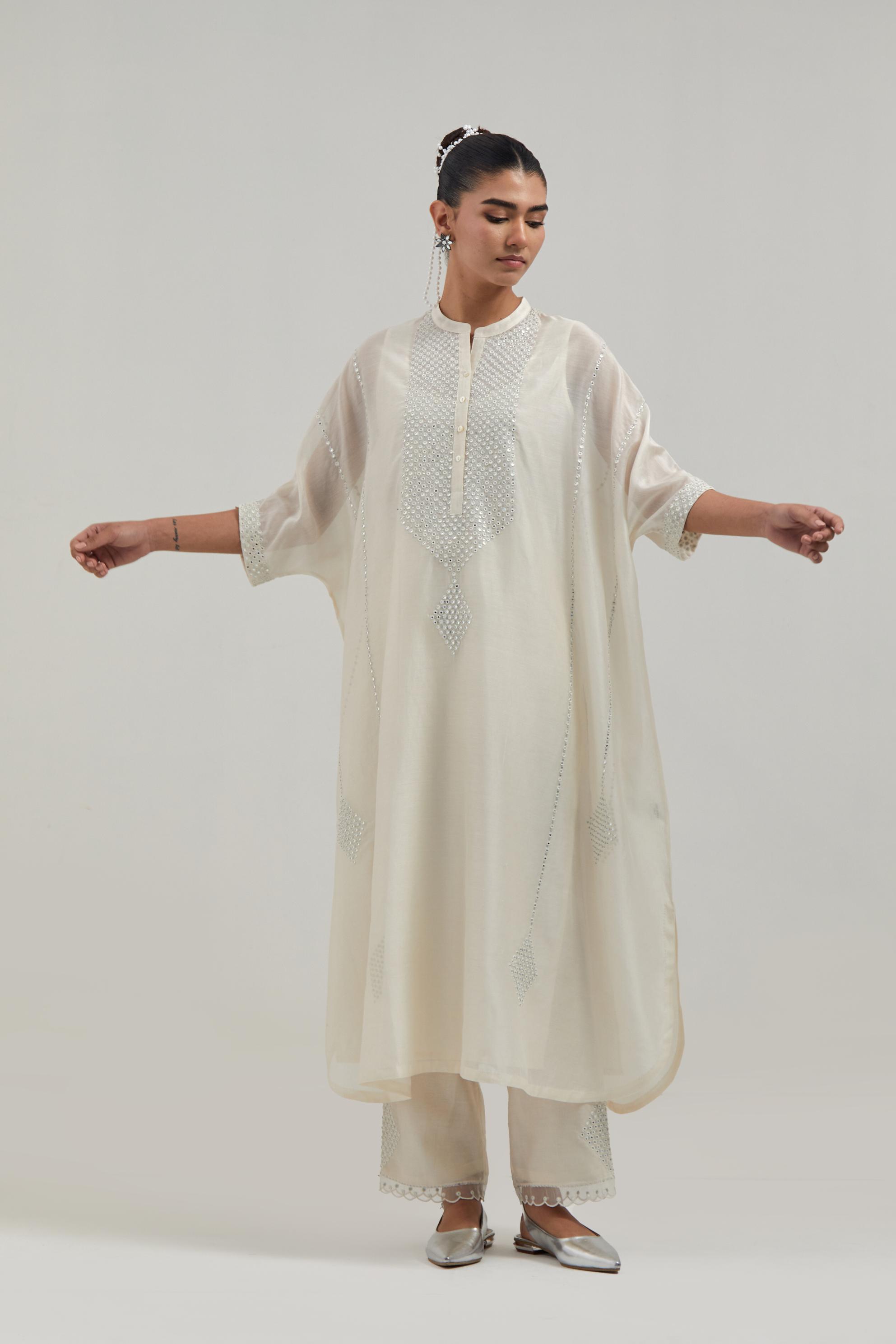 Off white silk Chanderi long kaftan with hand-embroidered mirror and sequins at the neck and diamond motifs along the sides, paired with Off white silk Chanderi straight pants with narrow organza scalloped hem and hand-embroidered diamond motifs.