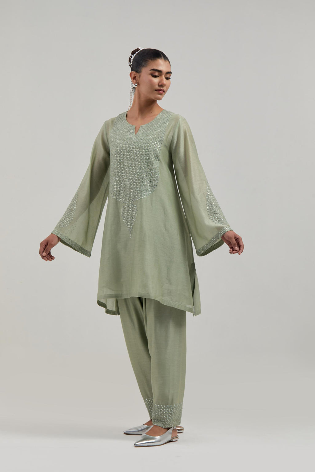 Green silk Chanderi short A-line kurta set with hand-embroidered mirror work at the neck and bell sleeves.