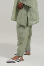 Green silk Chanderi short A-line kurta set with hand-embroidered mirror work at the neck and bell sleeves.