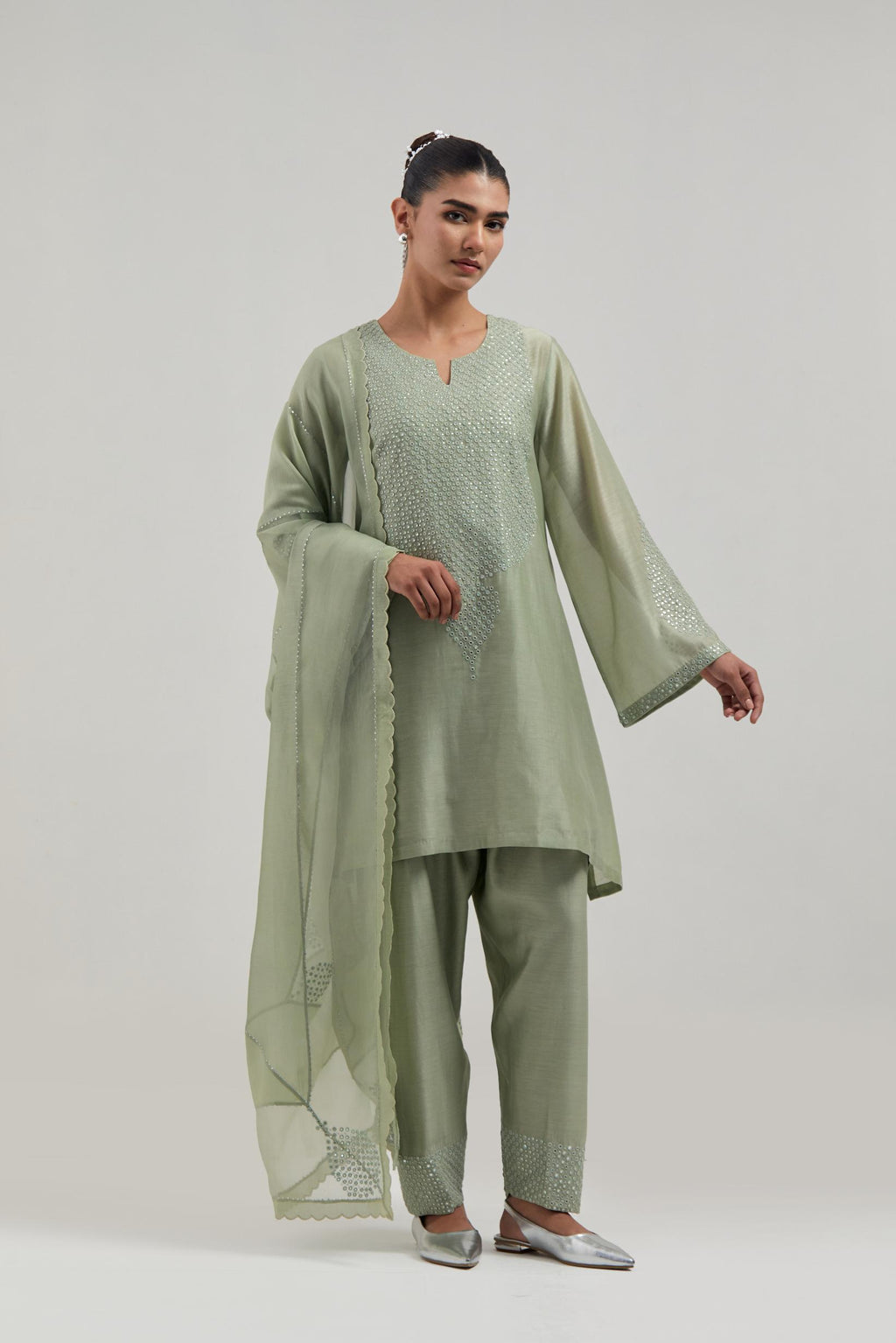 Green silk Chanderi short A-line kurta set with hand-embroidered mirror work at the neck and bell sleeves.