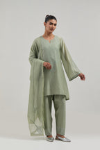 Green silk Chanderi short A-line kurta set with hand-embroidered mirror work at the neck and bell sleeves.