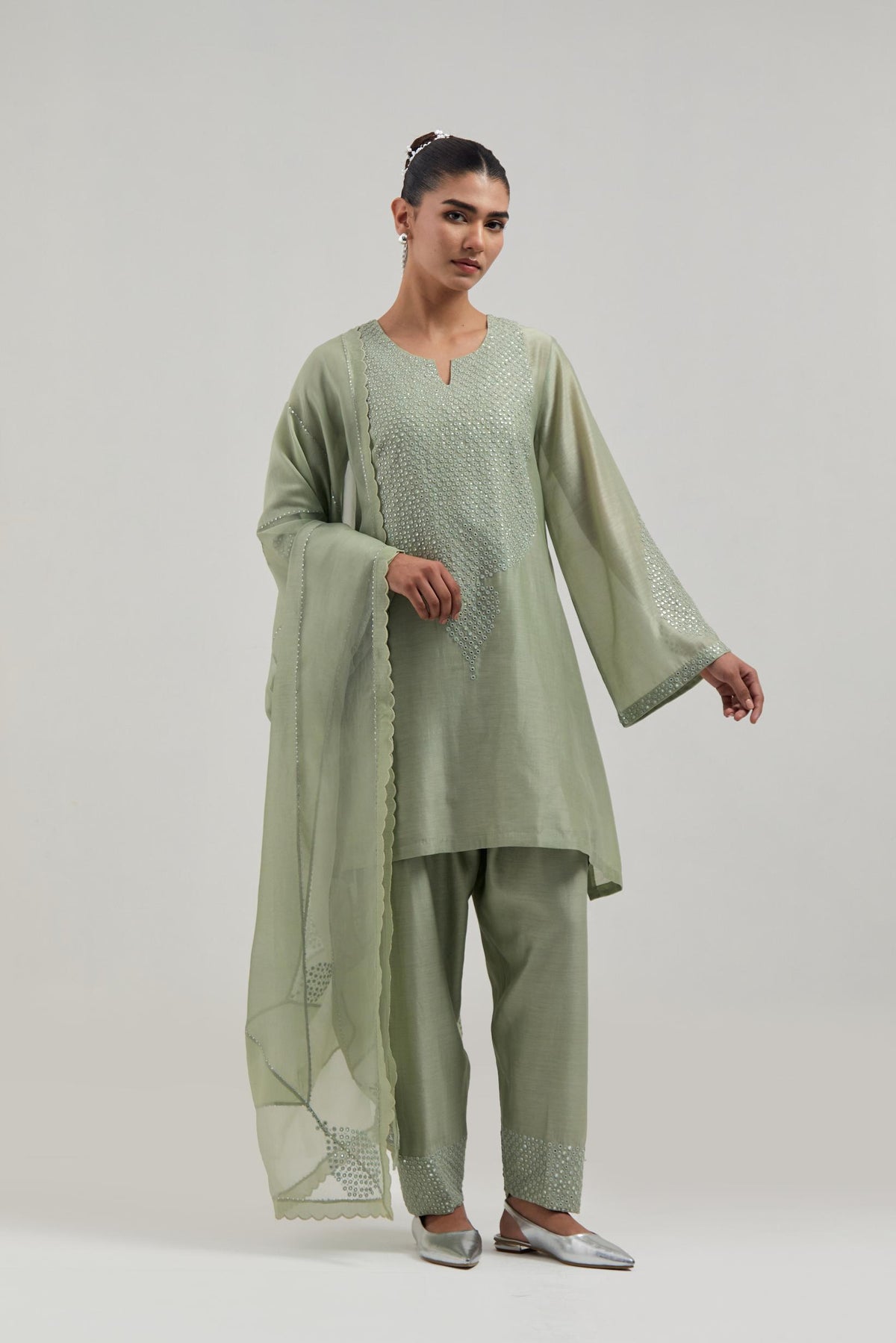 Green silk Chanderi short A-line kurta set with hand-embroidered mirror work at the neck and bell sleeves.