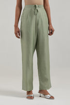 Green Silk Chanderi pants with hand embroidered leaf motifs with delicate mirror & sequins work at hem.