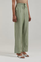 Green Silk Chanderi pants with hand embroidered leaf motifs with delicate mirror & sequins work at hem.