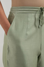 Green Silk Chanderi pants with hand embroidered leaf motifs with delicate mirror & sequins work at hem.