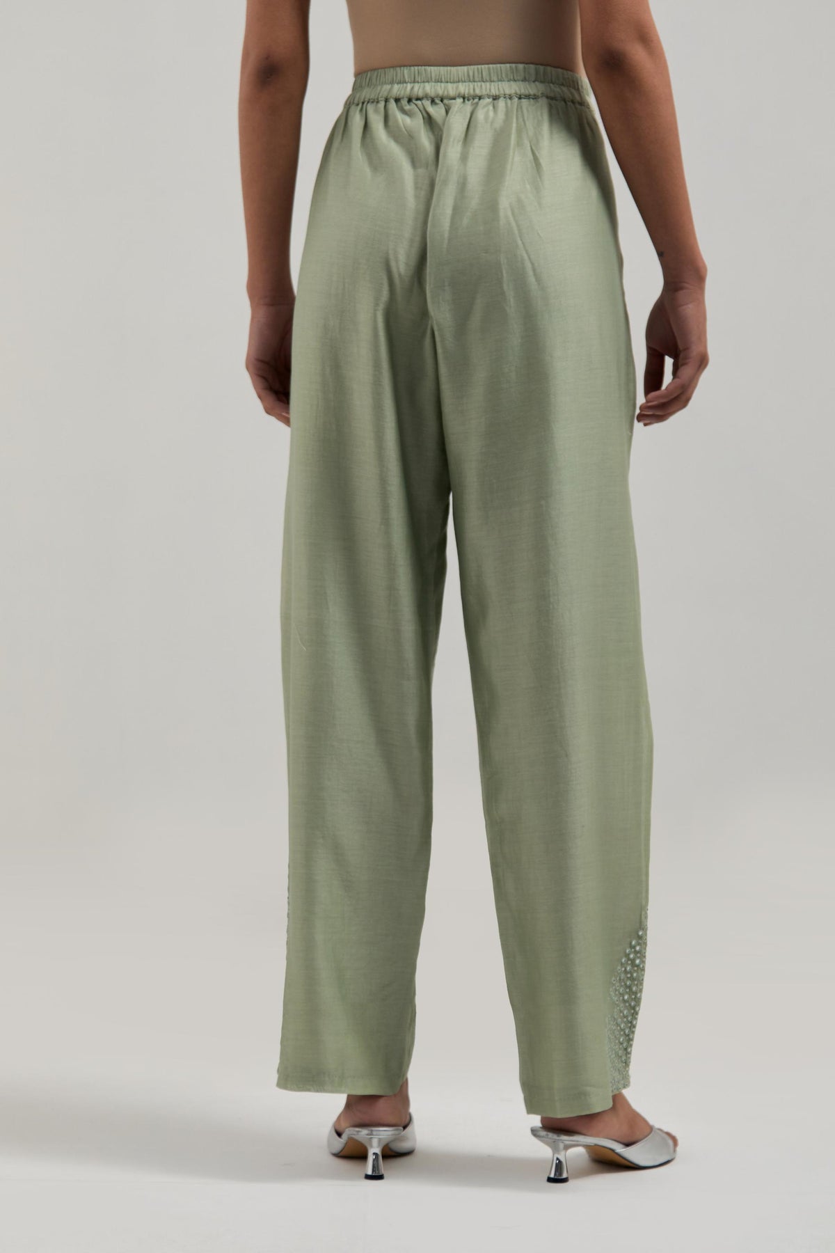 Green Silk Chanderi pants with hand embroidered leaf motifs with delicate mirror & sequins work at hem.