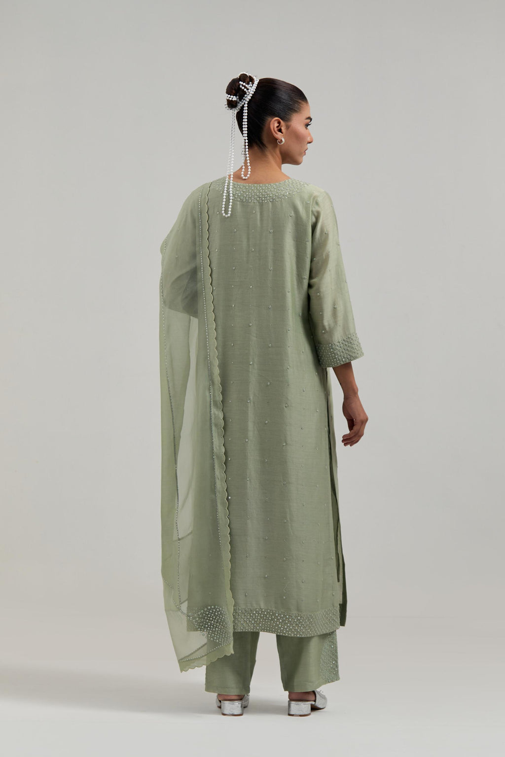Green silk Chanderi straight kurta set with hand-embroidered mirror at the neck, hem and sleeves, highlighted with scattered silver sequin and mirror embellishments all-over.