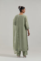 Green silk Chanderi straight kurta set with hand-embroidered mirror at the neck, hem and sleeves, highlighted with scattered silver sequin and mirror embellishments all-over.