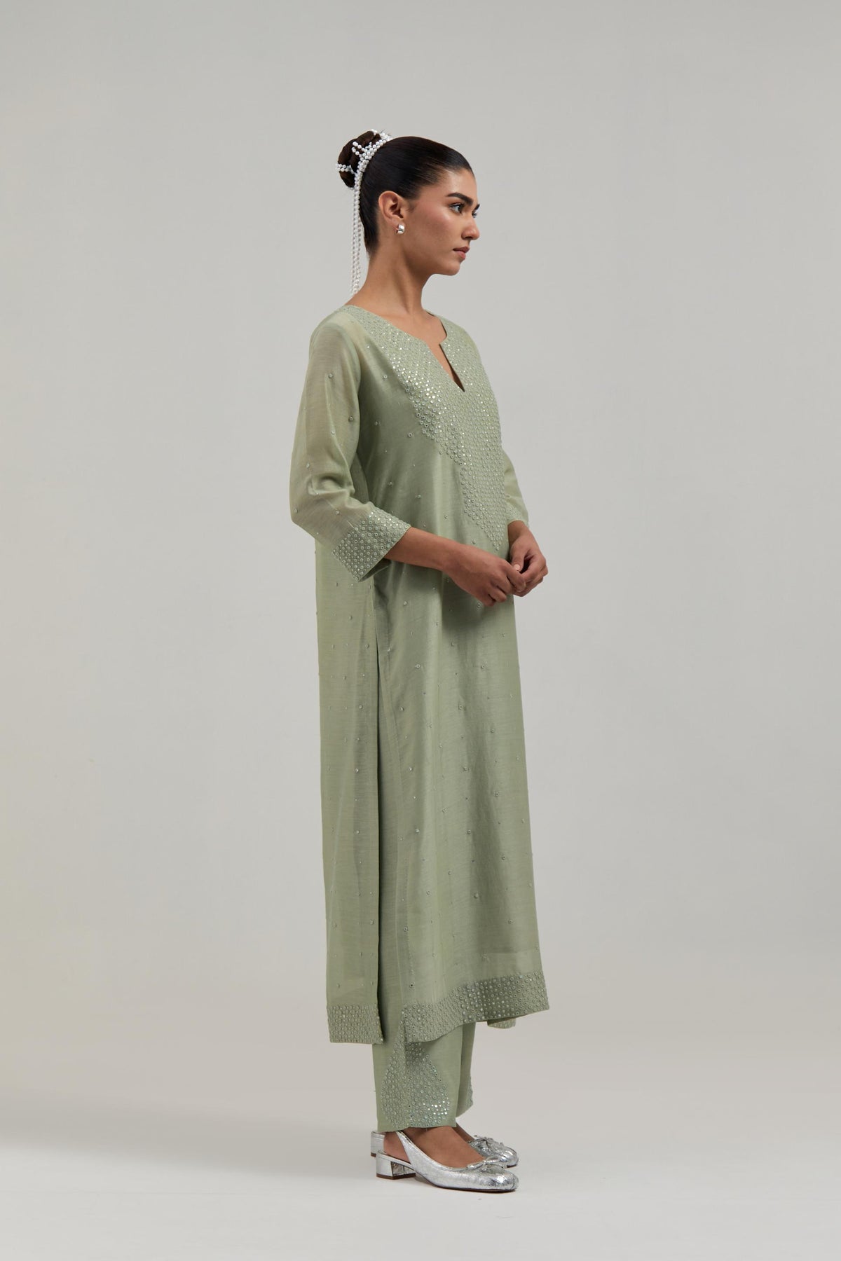 Green silk Chanderi straight kurta set with hand-embroidered mirror at the neck, hem and sleeves, highlighted with scattered silver sequin and mirror embellishments all-over.