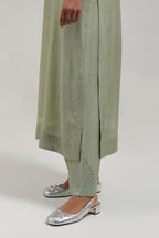 Green silk Chanderi straight kurta set with hand-embroidered mirror at the neck, hem and sleeves, highlighted with scattered silver sequin and mirror embellishments all-over.