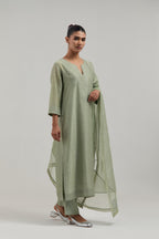 Green silk Chanderi straight kurta set with hand-embroidered mirror at the neck, hem and sleeves, highlighted with scattered silver sequin and mirror embellishments all-over.